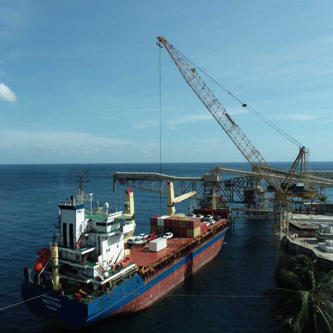 PRL Shipping's MV Red Titan docked near cranes on Christmas Island